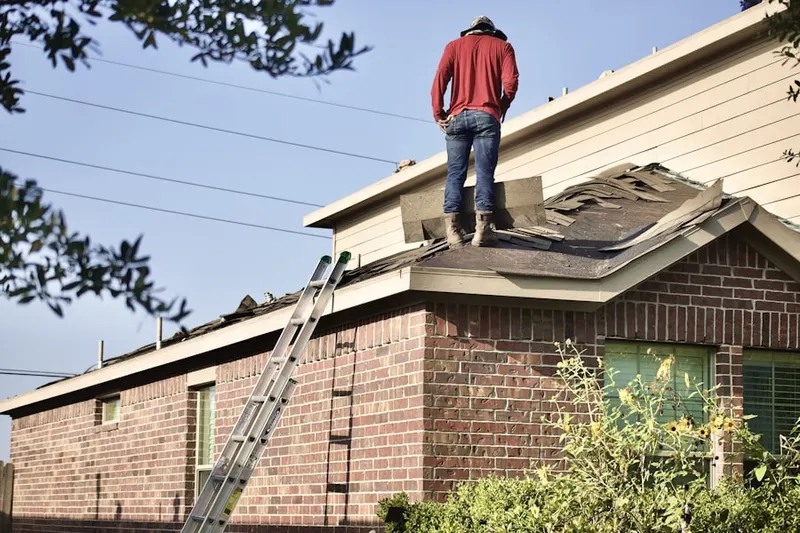 Professional roofer working on a residential roof in Broomfield